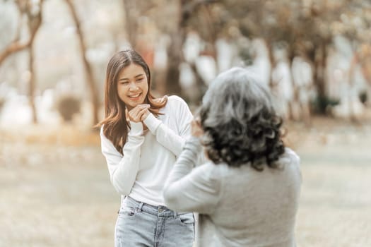 Portrait of an adult daughter with her elderly mother and take a photo and happy moment.