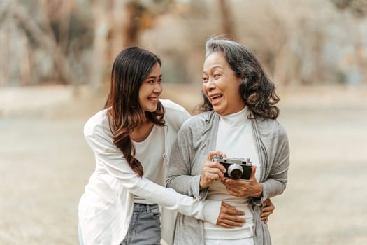 Portrait of an adult daughter with her elderly mother with hug and happy moment.