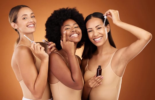 Diversity, women and with makeup lotion for cosmetics, natural beauty and skincare with brown studio background. Portrait, girls and smile with eyecare, cream and oils for wellness, happy or collagen.