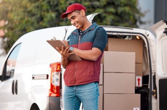 Delivery, inventory and courier writing on paperwork while working in the ecommerce business. Happy, young and logistics worker with smile for documents, paper and transportation of boxes in a van.