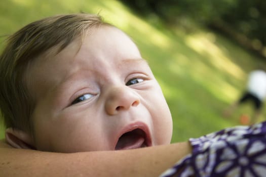 Two month old baby about to start crying. No happy expression