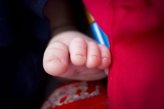 Two month old baby feet on black background. Sweet scene