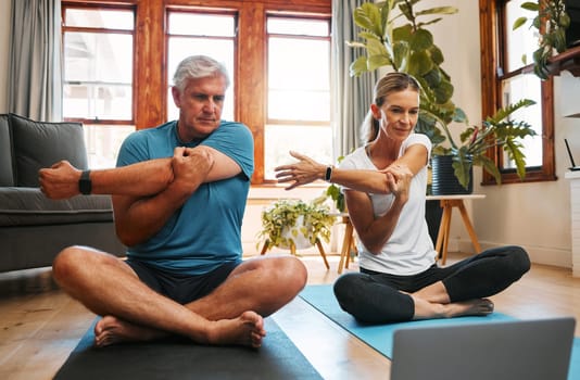 Couple, stretching and yoga with laptop to watch online video tutorial. Senior man and woman warm up with pilates and exercise on virtual class on the floor with peace, fitness and training.