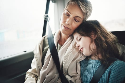 Woman and girl in car sleeping during road trip, journey or drive for travel, vacation or holiday. Grandmother, child and sleep in van, vehicle or transportation for rest together as family.