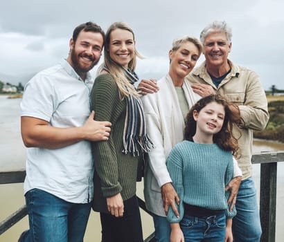 Family, travel and vacation with a girl, parents and grandparents on holiday or a weekend getaway by a lake. Nature, children and portrait with a happy group of relatives outdoor on the water.