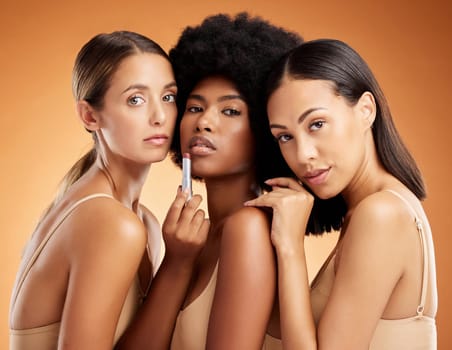 Lipstick, makeup and women with product for beauty against an orange studio background. Face portrait of a model group with facial cosmetics for skincare, body wellness and diversity of people.