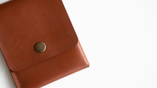 Orange genuine leather card holder on a white surface.