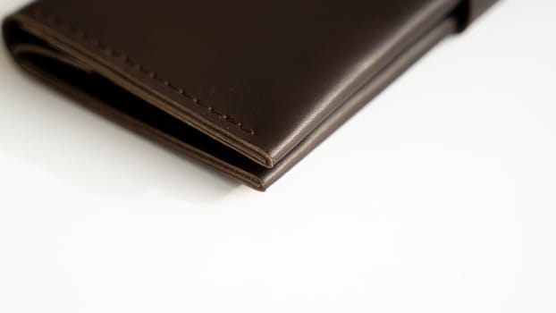 Details of brown elegance men's leather wallet on a white background. Mens leather accessories. Natural leather