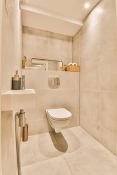 a bathroom with a toilet, sink and mirror on the wall next to it is an image of a man's reflection