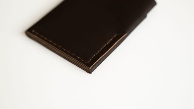 Brown empty men's business handmade leather card holder with isolated on white background. Selective focus, copy space, close up