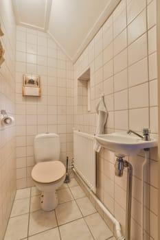 a bathroom with white tiles on the walls, and a toilet in the corner next to the sink is empty