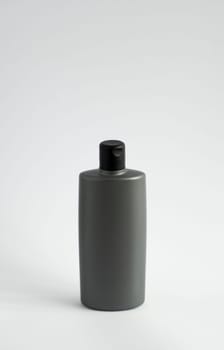 Black shampoo packaging mockup. Vertical empty plastic cosmetic package for man, isolated on white background. Container of conditioner, hair rinse