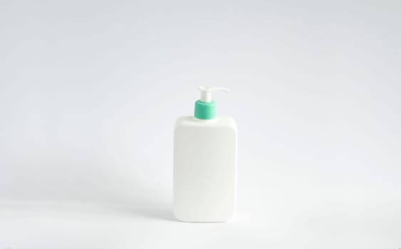 Large white plastic bottle with pump dispenser as a liquid container for gel, lotion, cream, shampoo, bath foam on white background
