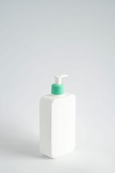 Large white plastic bottle with pump dispenser as a liquid container for gel, lotion, cream, shampoo, bath foam on white background