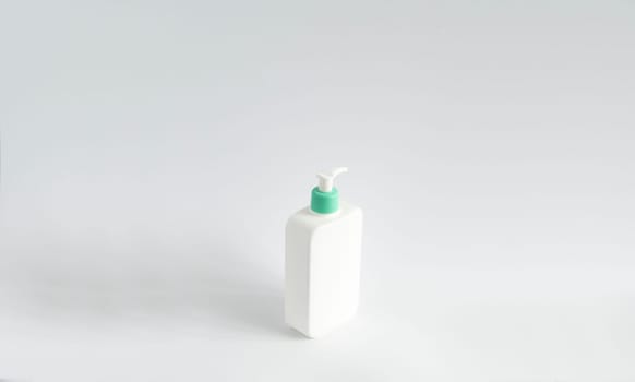 Large white plastic bottle with pump dispenser as a liquid container for gel, lotion, cream, shampoo, bath foam on white background