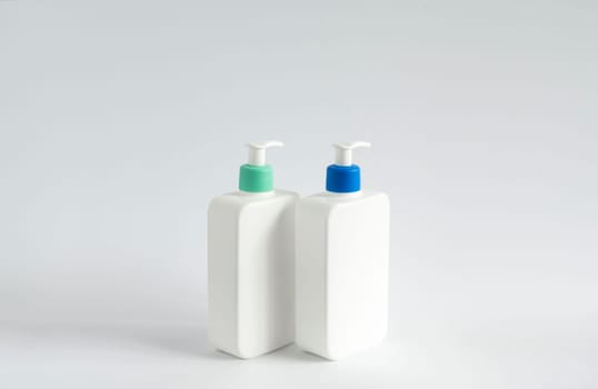 Two liquid containers for shampoo, gel, lotion, cream, bath foam etc. Blank unbranded cosmetic plastic bottles with dispenser pump