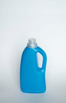 Softener in blue plastic bottle isolated on white background. Bottle with liquid laundry detergent, cleaning agent, bleach or fabric softener. Product design. Mock up