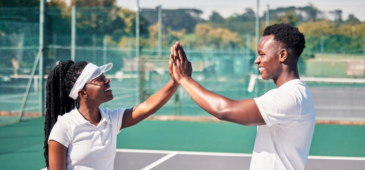 High five, tennis and sports couple or black people with success, competition congratulations or support in game collaboration. Tennis court, athlete and fitness friends with mission or yes hand sign.