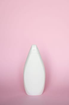 White bottle for liquid soap, shampoo, gel on pink background