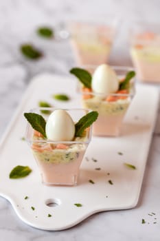 mini portions of salmon and cream mousse decorated with mint leaves, chick imitation, Easter appetizer