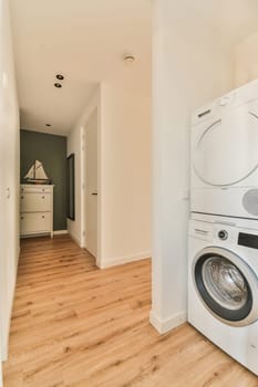 a laundry room with washer, dryer and washing machine on the floor in front of an open door