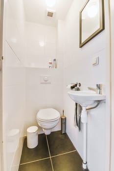 a small bathroom with a sink and toilet paper disped on the wall next to it is a mirror