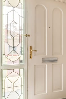 a white door with stained glass in the front and side panels on the outside, as seen from the inside