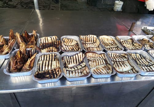 Roasted ripe artichoke and eggplant for sale at the market in Catania, Sicily