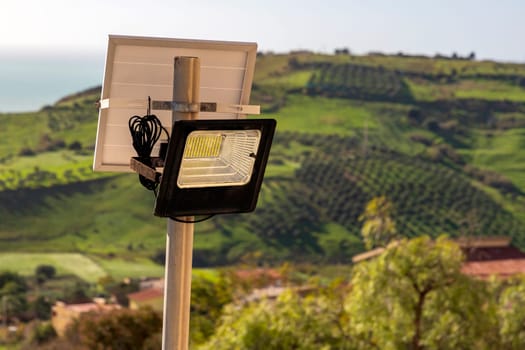 Outdoor LED lamp with solar panel. Modern square urban design. City lighting equipment.
