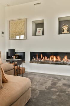 Amsterdam, Netherlands - 10 April, 2021: a living room with a fireplace in the middle and pictures on the wall above it to show what you are looking for