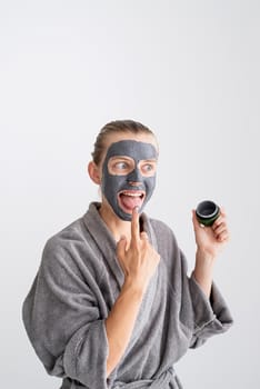 Womens health. Spa and wellness. Happy funny woman applying face mask and tasting it