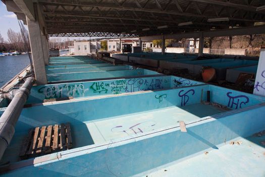 Old tanks for the fish processing, Villaggio del Pescatore. Italy