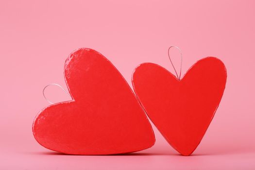 Two heart shaped gift boxes on bright pink background. Concept of St. Valentine's day, love and couple's gifts for holidays and anniversary. 