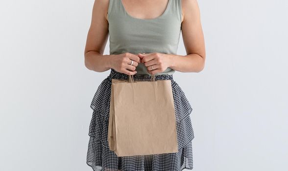 Online shopping concept. Young woman holding eco friendly shopping bags