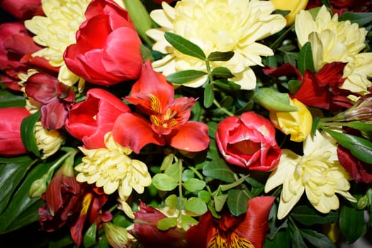 Bright bouquet of different flowers. Mixture of different colors of artificial carnations, for decoration