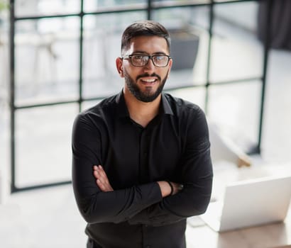 Businessman portrait. Happy confident young businessman standing , smiling, looking at camera.