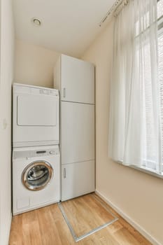 a laundry room with a washer and dryer on the floor next to a window in an empty room