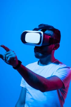 Brunette man with in white t-shirt with glasses of virtual reality. Future technology concept