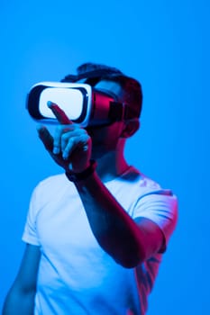 Man wearing virtual vr goggles. Young bearded man wearing virtual reality headset. VR concept