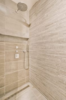 a bathroom with tile on the walls and shower head mounted to the wall, it is clean and ready for use