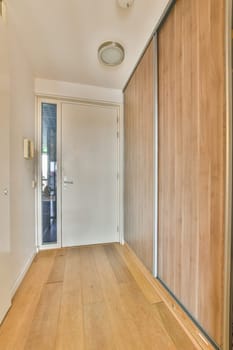 an empty room with wood flooring and white trim on the walls, door is open to let light into the room