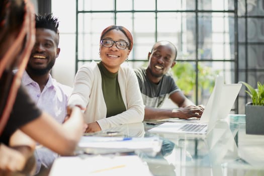 african business people handshaking at modern office