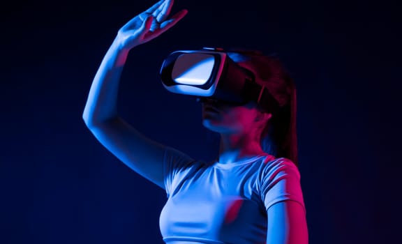 Woman wearing a VR headset and interacting with virtual reality interfaces. Technology, Video Game and Metaverse Concept
