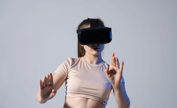 Brunette female wearing Virtual reality googles and watching a video or playing a games with a friends