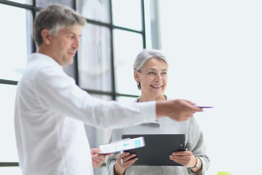 Businessman and woman working on computer together