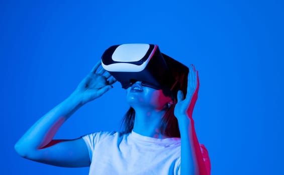 Impressed brunette woman using virtual reality headset, getting immersed experience, interacting with immersive digital world, testing VR technology for work
