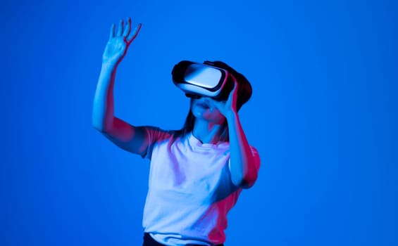 Excited brunette woman in vr headset in a studio
