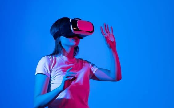 Brunette woman architect or engineer wearing VR headset for working design 3D architectural model in virtual reality space