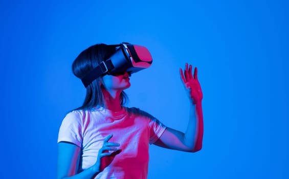 Young brunette woman in white t-shirt wearing vr headset. Metaverse concept vr future girl