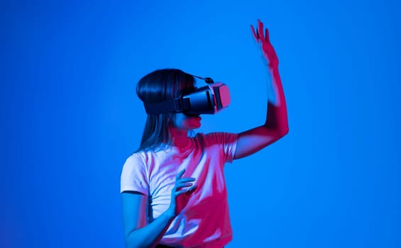 Woman getting experience in metaverse using VR headset glasses. Exploring a cyberspace via virtual reality